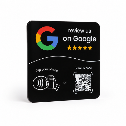 A square black Google review magnet or plaque on a white background, featuring the Google logo, the text 'review us on Google' with five stars, and instructions to tap your phone or scan QR code.